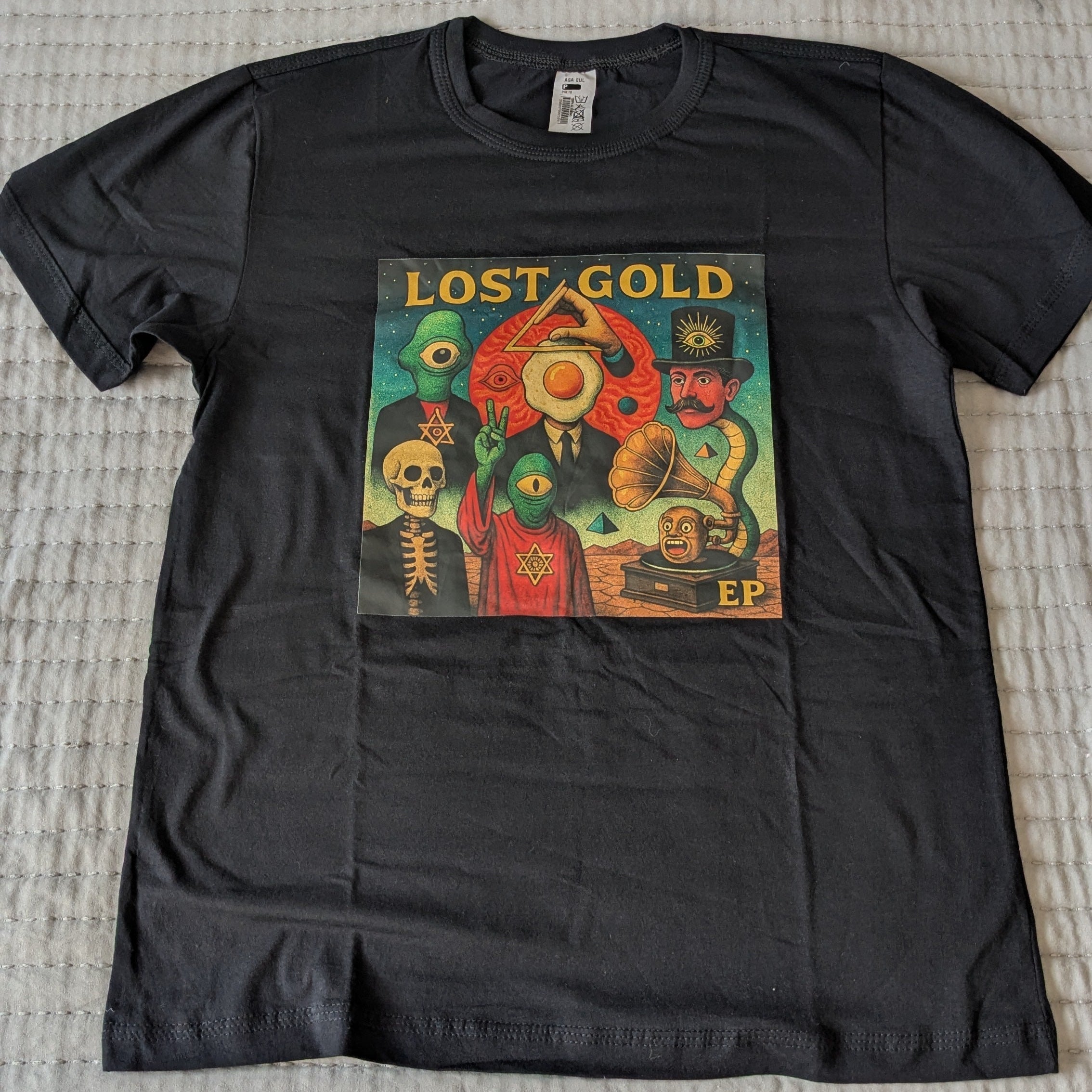 Black t-shirt with a colorful graphic design on a textured surface