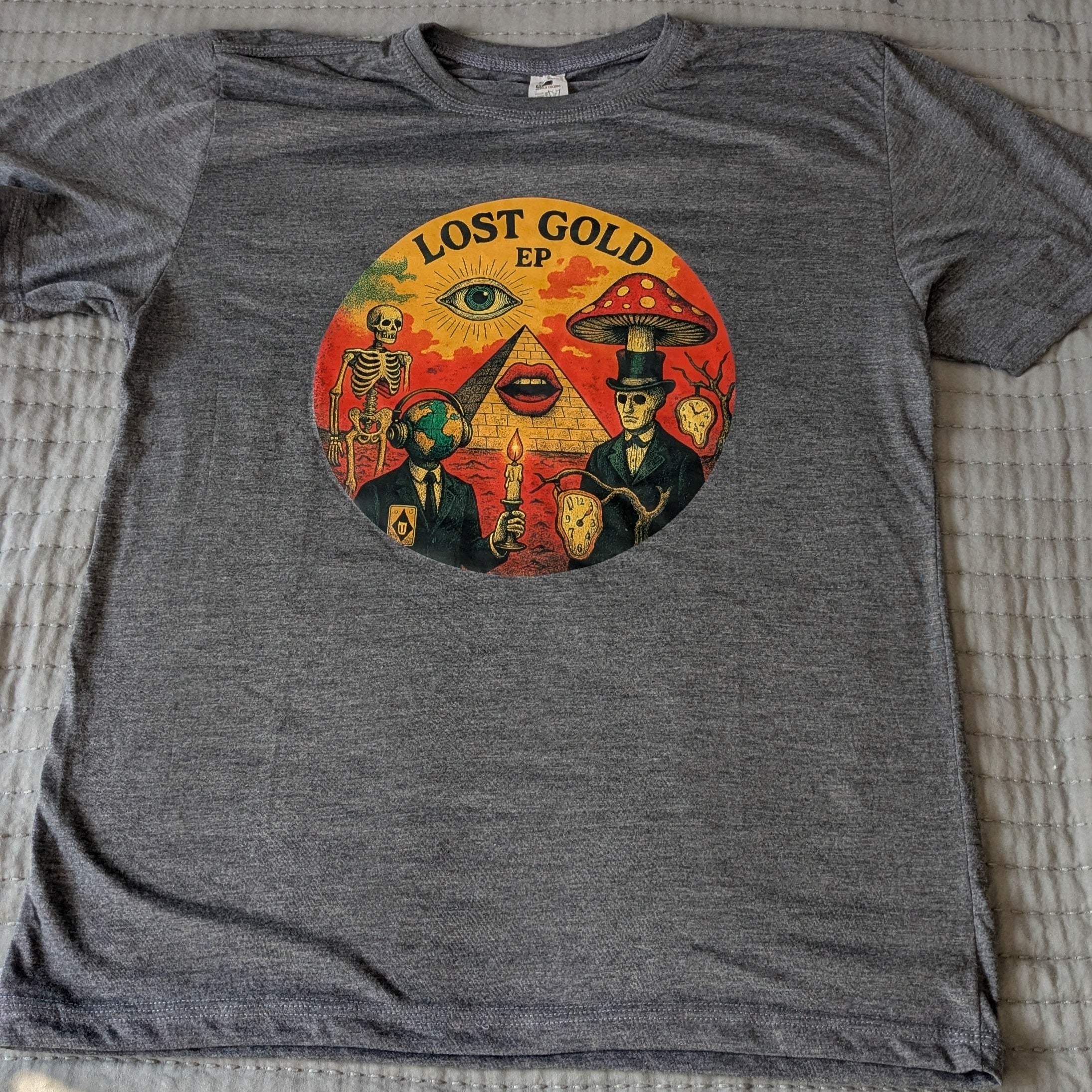 Gray t-shirt with a colorful graphic design on a textured surface