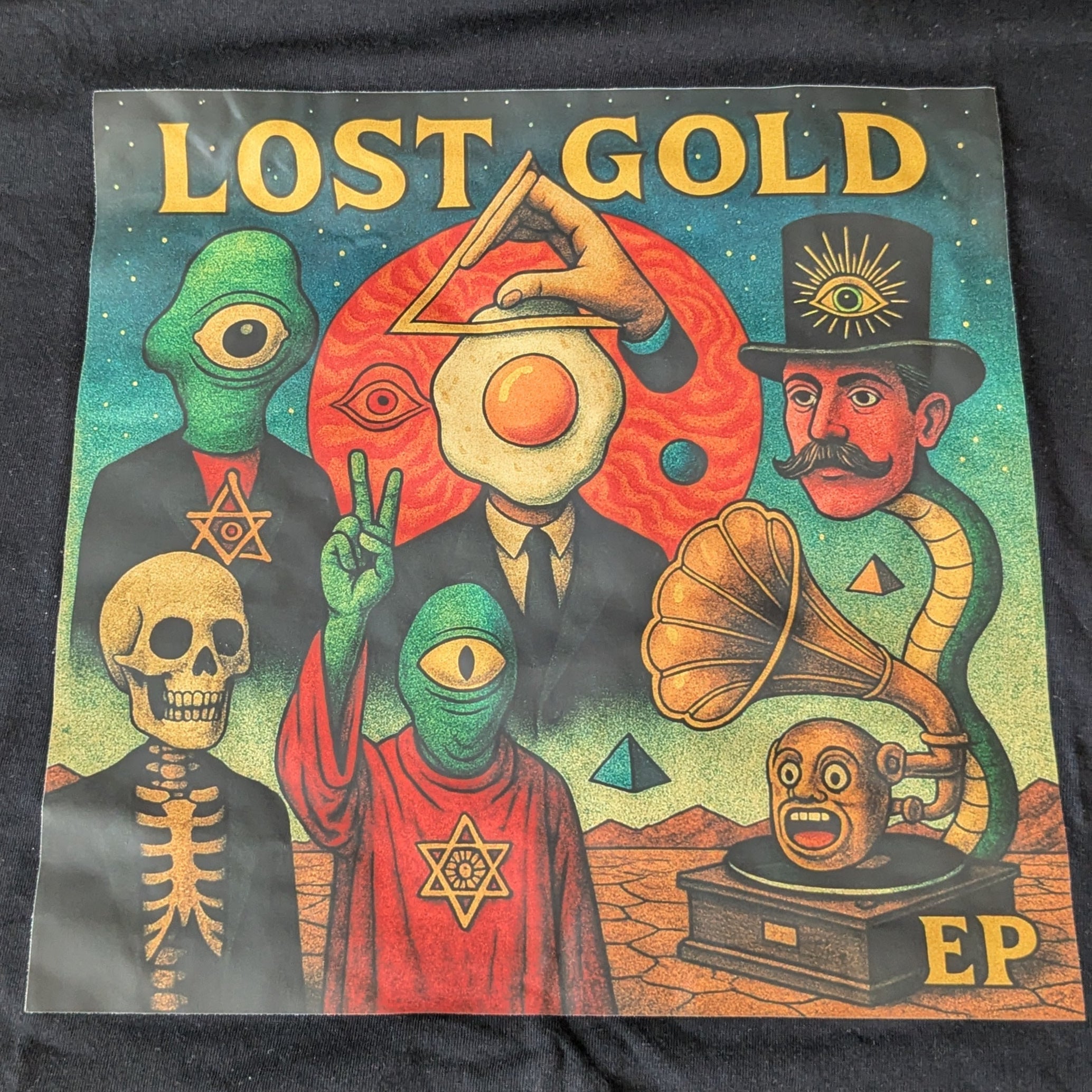 Black t-shirt with 'Lost Gold' EP cover design on a textured surface
