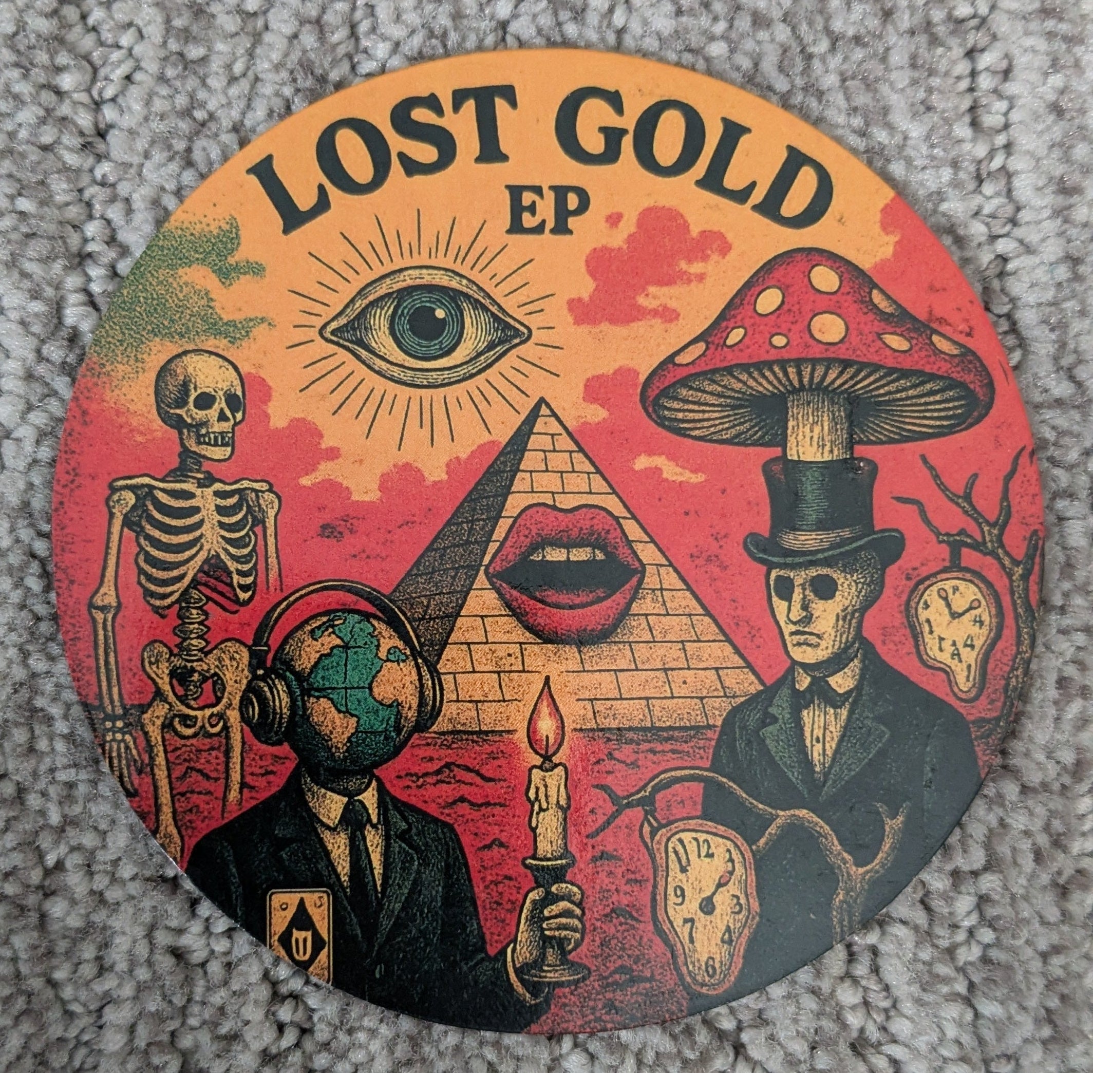Round magnet with 'Lost Gold EP' design featuring symbols like a pyramid, eye, and skeletons on a textured gray background.